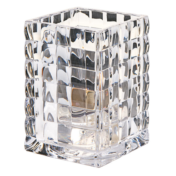 A Hollowick clear glass square candle holder with a candle inside.