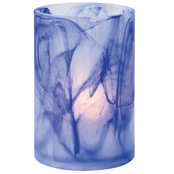 A dark blue glass cylinder candle holder with a swirl design.