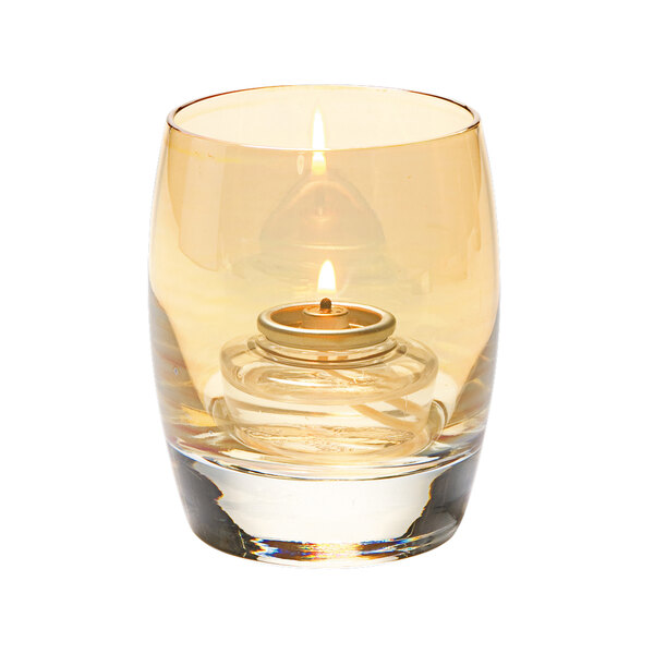 A Hollowick Contour gold luster glass votive with a lit candle inside.