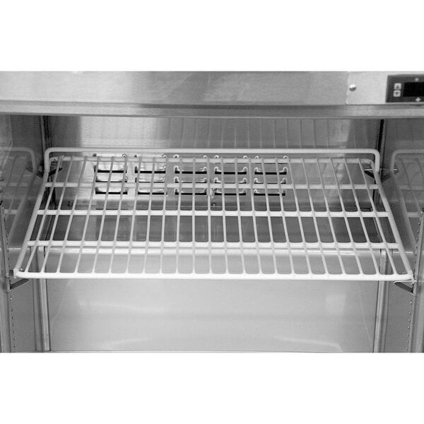 A white coated wire rack shelf for an Avantco prep refrigerator.