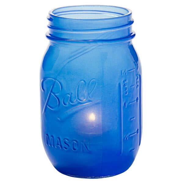 A Dark Blue Satin glass jar with a lid.