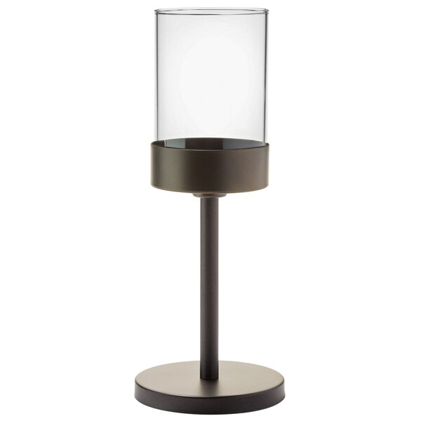 A clear glass cylinder on a dark bronze Hollowick candlestick stand.