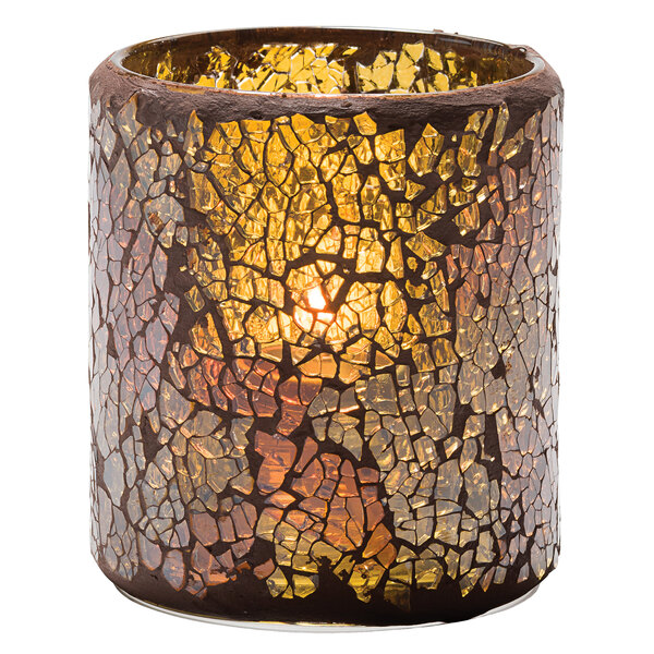A Hollowick crackle gold glass votive candle holder with a lit candle inside.