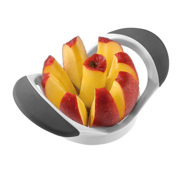 A Westmark stainless steel apple corer and slicer with sliced apples in a white and gray container.