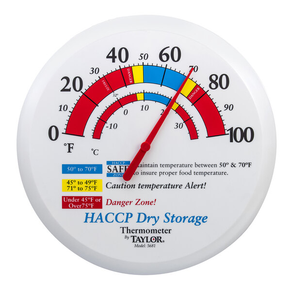 A white round Taylor wall thermometer with red and blue text that reads "HACCP Dry Storage"