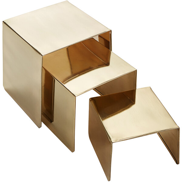 An American Metalcraft gold metal square riser set.