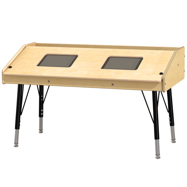 A Jonti-Craft wooden children's table with dual wood tablet spaces and rear storage.