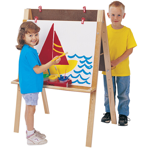 A boy and girl painting on a Jonti-Craft Double Adjustment Easel.