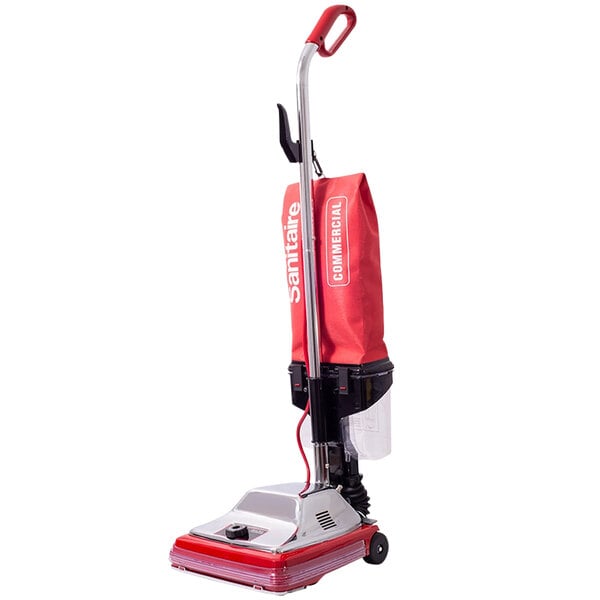 A red and black Sanitaire upright vacuum cleaner with a red handle.