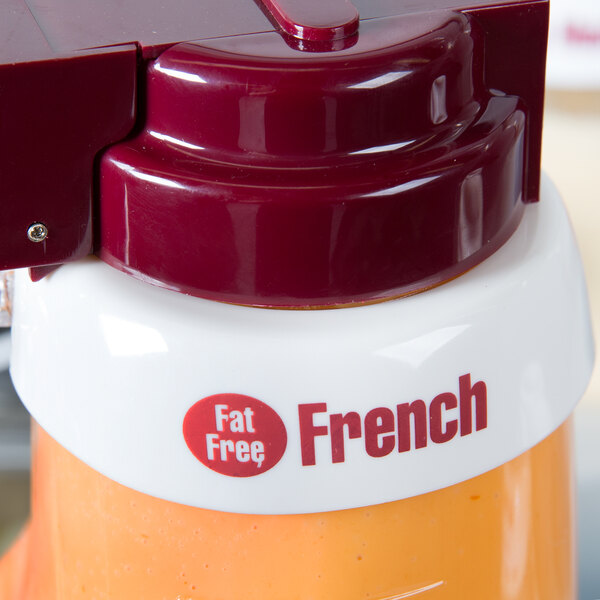A close up of a white Tablecraft plastic dispenser collar with maroon lettering.