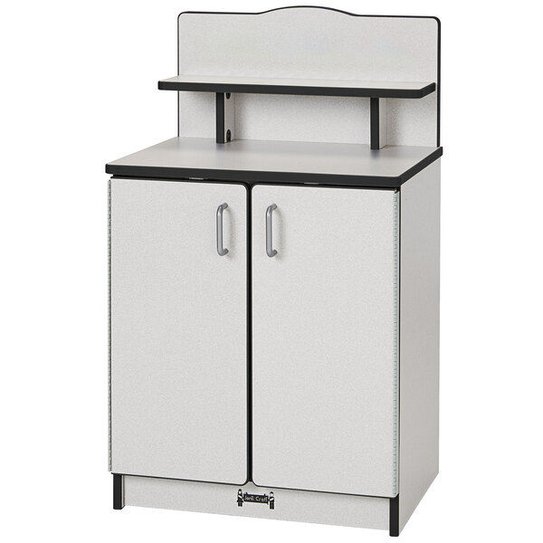 A white Rainbow Accents kitchen cupboard with a black top and shelf.