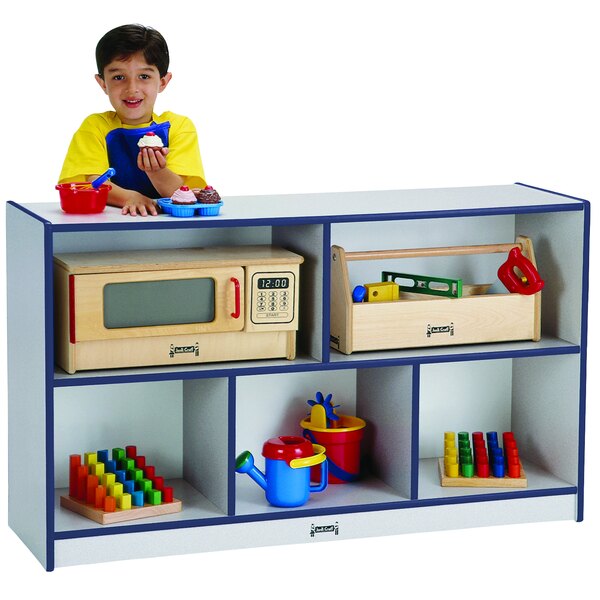 A child standing in front of a Rainbow Accents navy storage cabinet.