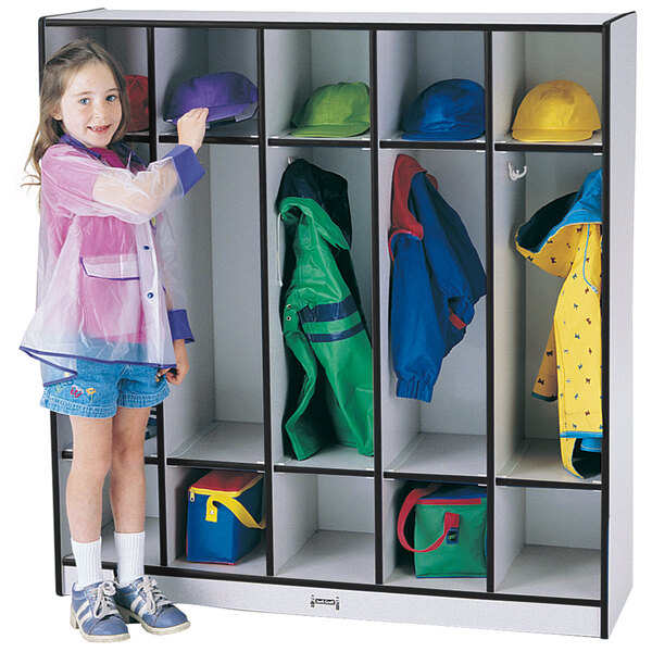 A little girl standing in front of a Rainbow Accents black and gray coat locker.