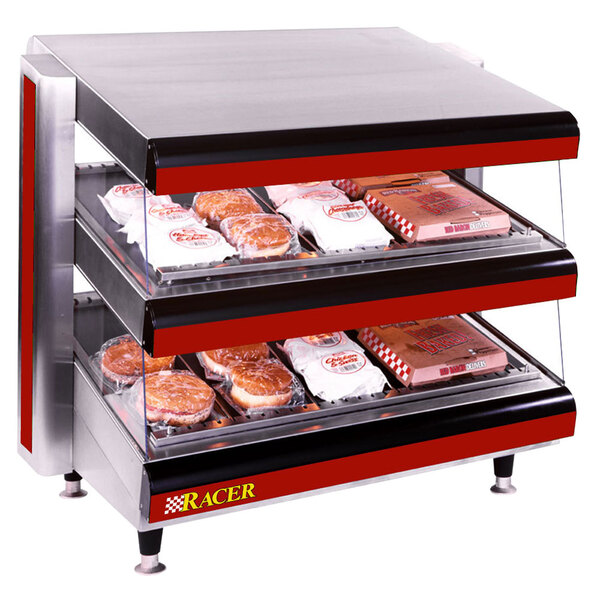 An APW Wyott countertop food display case with trays of donuts inside.