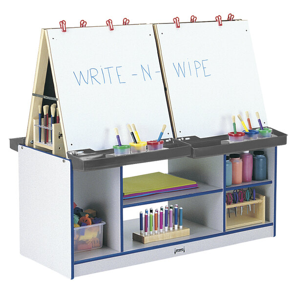 A blue and white Rainbow Accents art center with writing and drawing supplies on it.