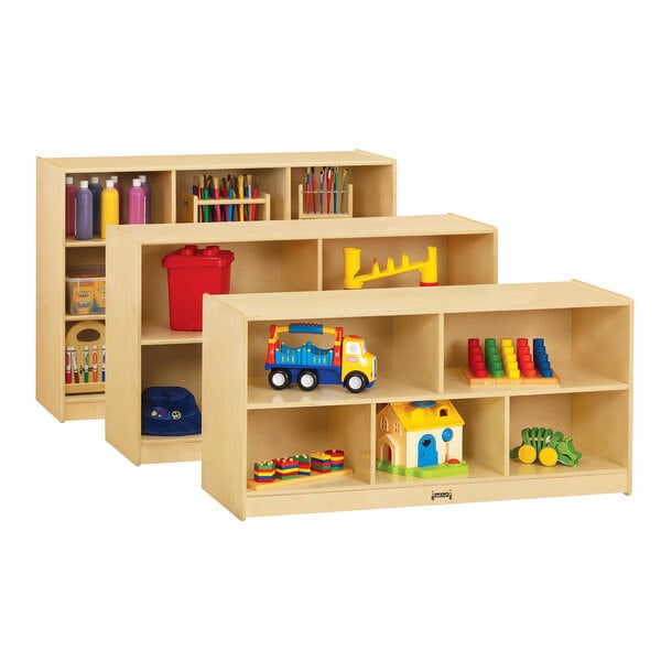 A Jonti-Craft wooden storage cabinet with shelves holding toys.