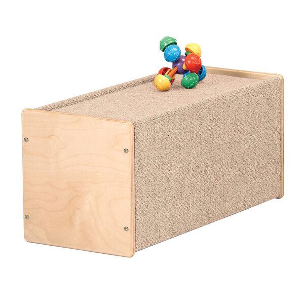 A Jonti-Craft wooden box with toys on top.