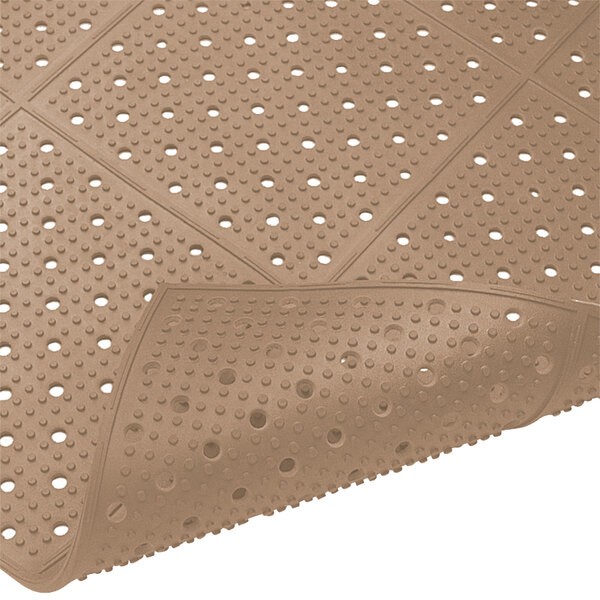 A close-up of a brown rubber Cactus Mat with holes in it.