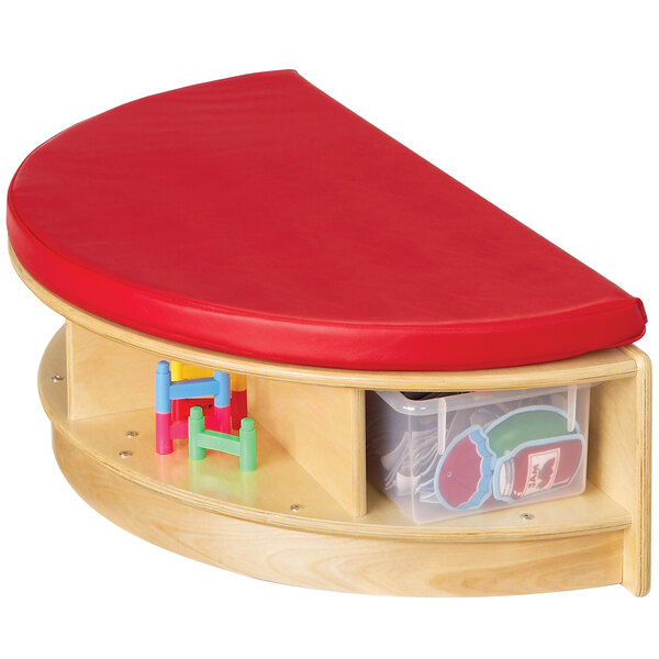 A Jonti-Craft red cushioned semi-circle wooden bench with clear trays on shelves.