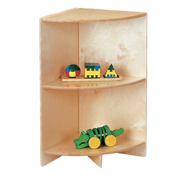 A Jonti-Craft wooden corner storage cabinet with wooden toys on the shelves.