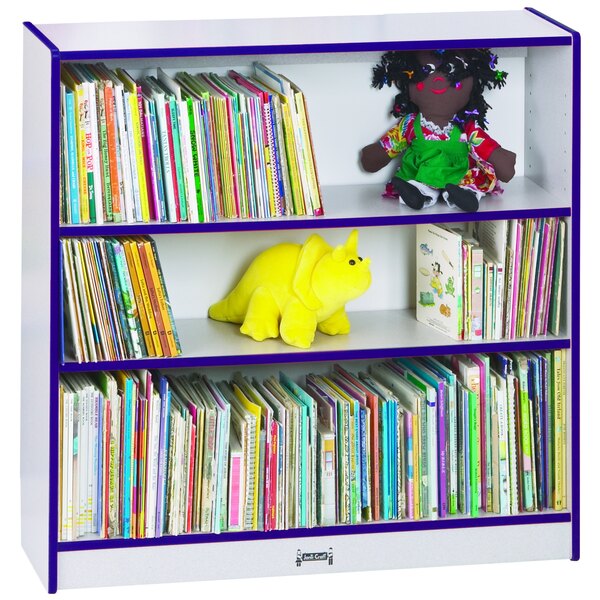 A Rainbow Accents purple bookcase shelf with books and stuffed toys.