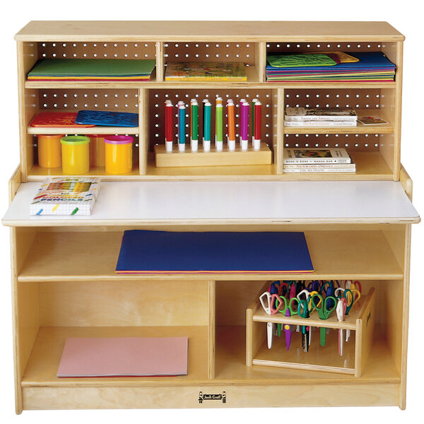 A Jonti-Craft wooden desk with a pencil holder on top.