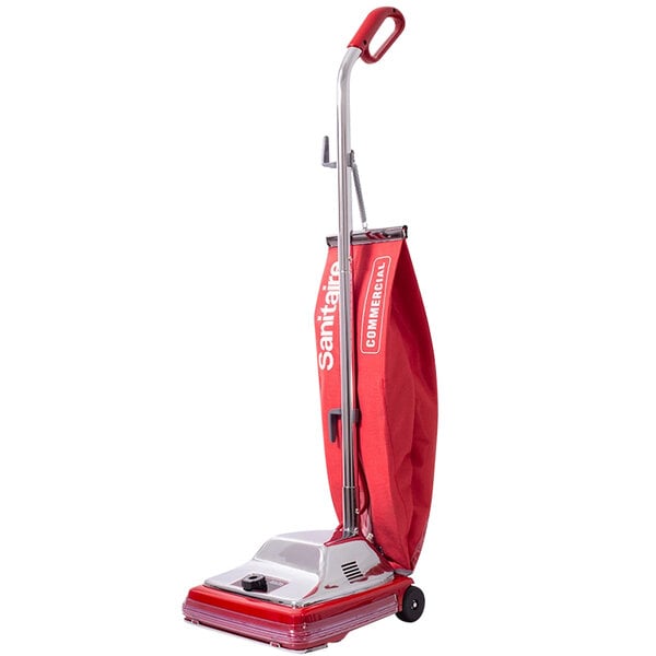 A red Sanitaire TRADITION vacuum cleaner with a red bag and cover.