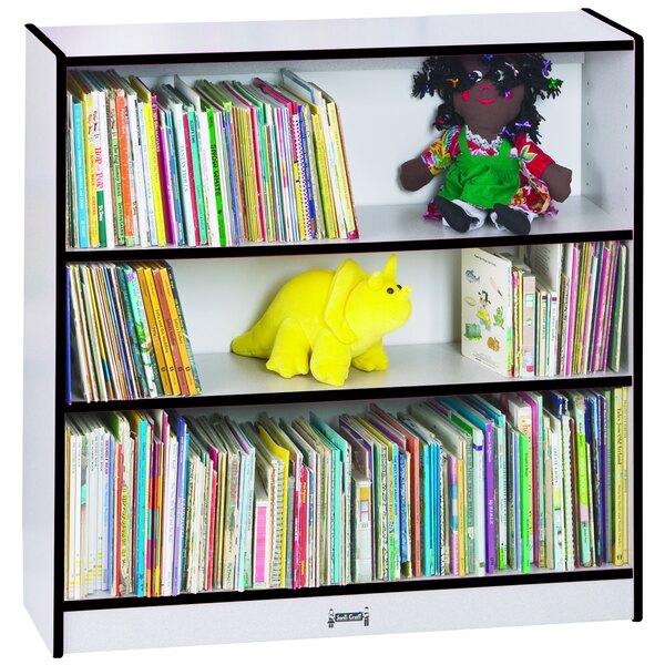 A Rainbow Accents black bookcase with books and stuffed toys on a shelf.