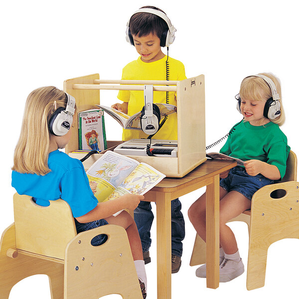 A group of children sitting at a table with headphones on using a Jonti-Craft wood caddie.