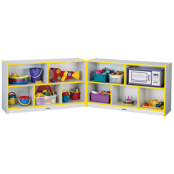 A white and yellow Rainbow Accents mobile storage cabinet filled with toys.