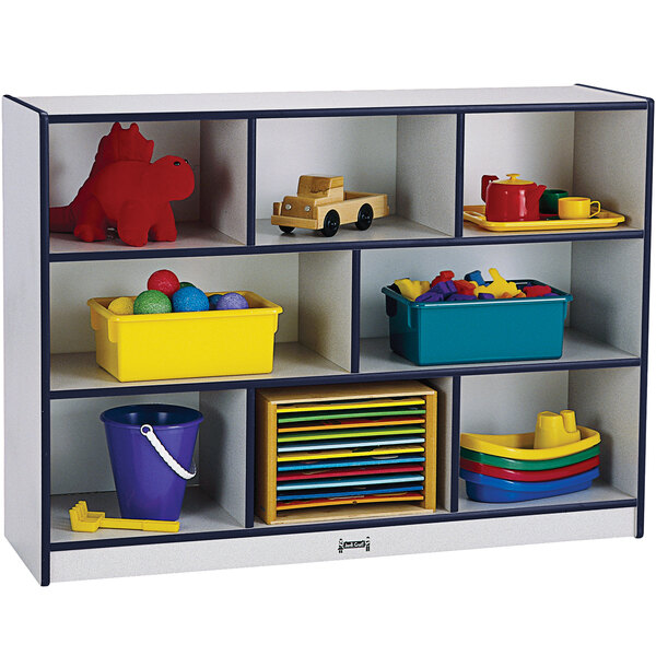 A Rainbow Accents navy, white, and grey mobile storage cabinet filled with toys.