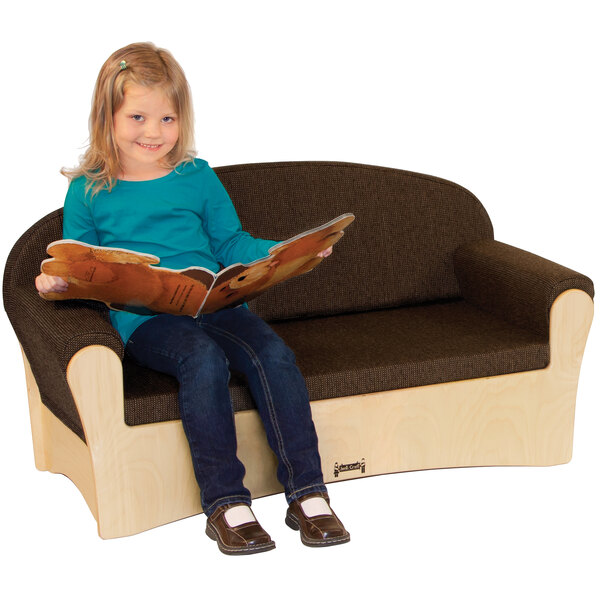 A girl sitting on a Jonti-Craft espresso wood sofa reading a book.