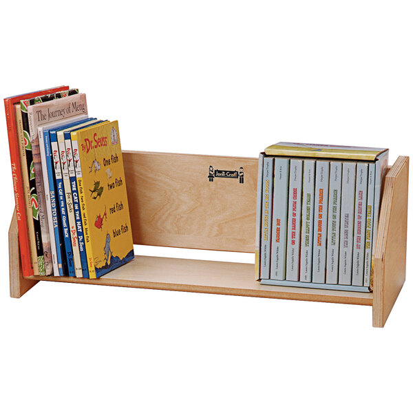A Jonti-Craft wooden book holder shelf with books on it.