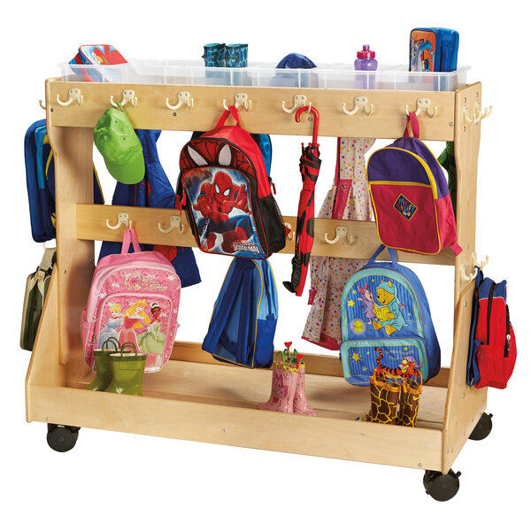A Jonti-Craft wooden mobile cart with clear plastic trays and backpacks hanging from hooks.