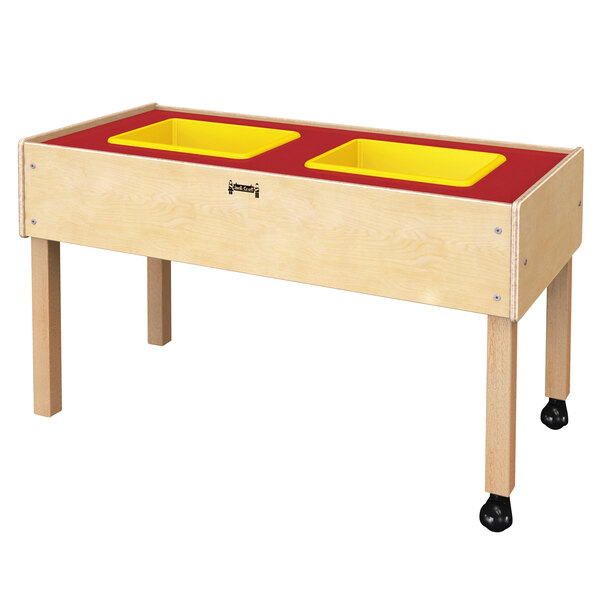 A Jonti-Craft wooden sensory table with two rectangular yellow bowls inside.