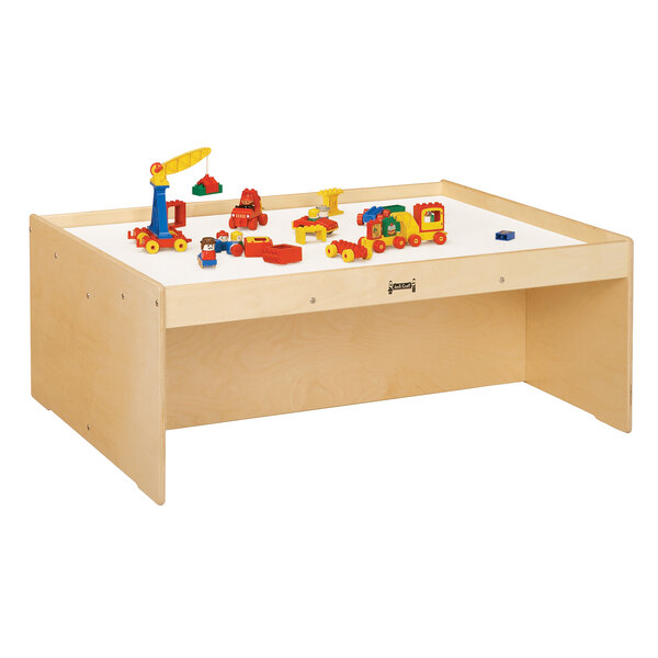 A Jonti-Craft wooden activity table with toys on it.