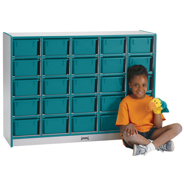 A child sitting next to a blue and white Rainbow Accents mobile storage cabinet.
