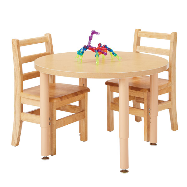 A Jonti-Craft Baltic Birch table and chair with a toy on it.