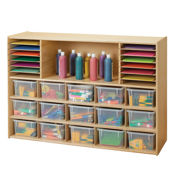 A Young Time natural wooden sectional cubbie storage unit with clear plastic bins.