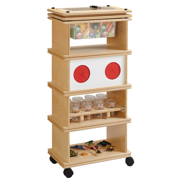 A Jonti-Craft Baltic Birch Science Lab System with wooden shelves and drawers holding toys.