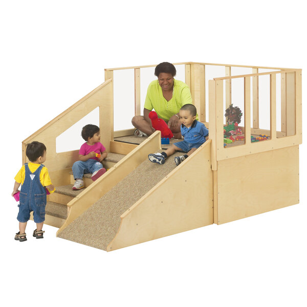 A child and a woman playing with a Jonti-Craft Tiny Tots play loft slide.