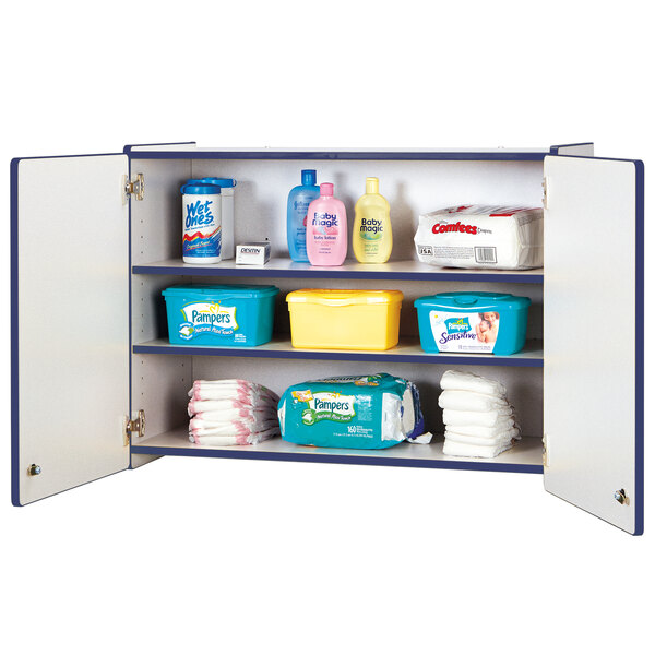 A Rainbow Accents navy wall-mount storage cabinet with baby products on a shelf.