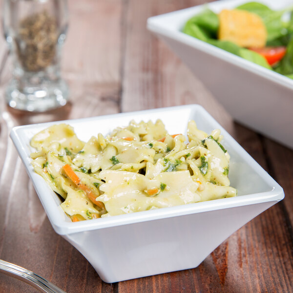 A white GET Siciliano square bowl filled with pasta and salad on a table.