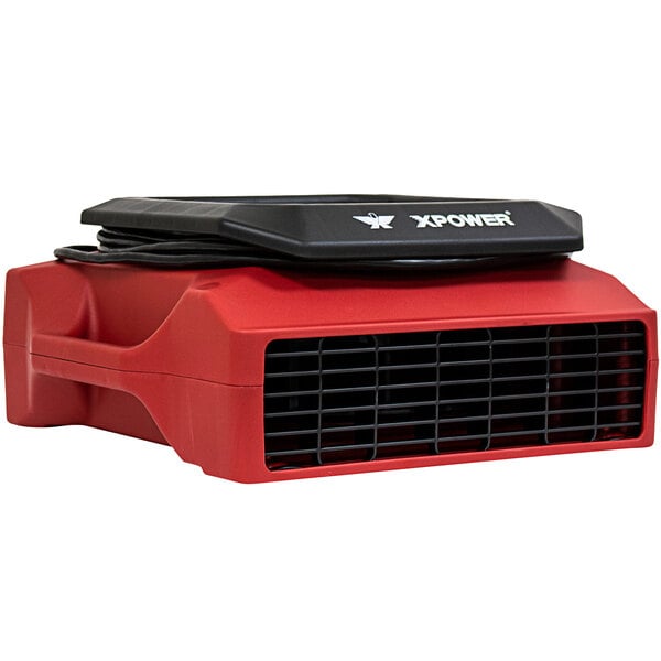 A red and black XPOWER air blower machine.