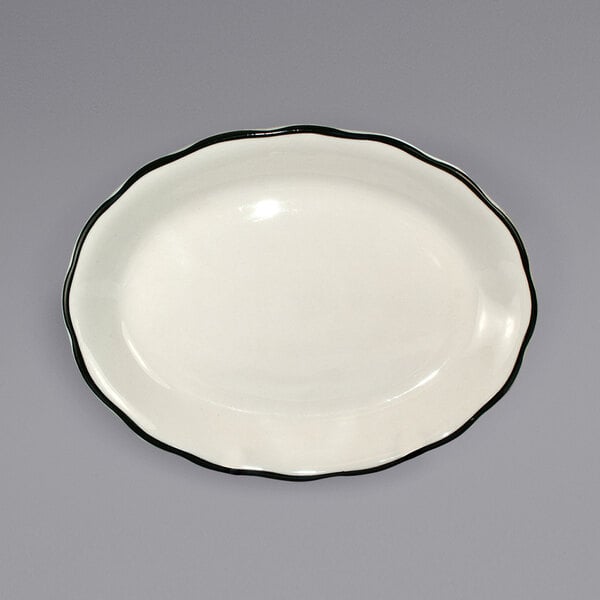 A white International Tableware stoneware platter with a black rim.