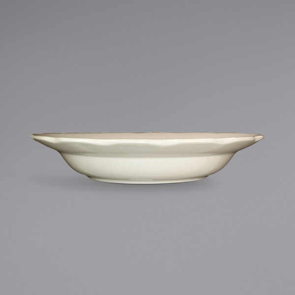 A white stoneware bowl with a wavy edge.