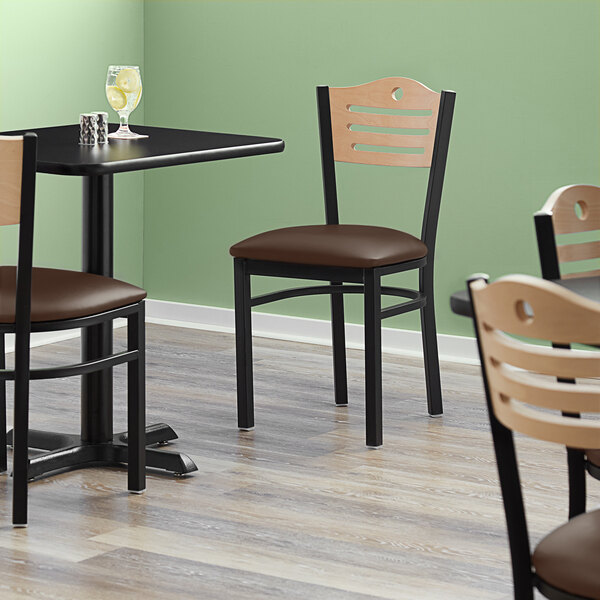 A Lancaster Table & Seating bistro chair with a dark brown vinyl seat and natural wood back.