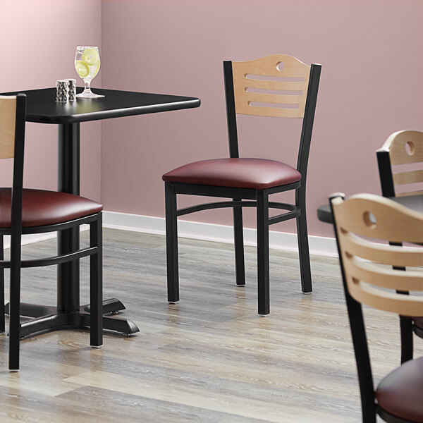 Lancaster Table & Seating Black Finish Bistro Chair with 2 1/2" Burgundy Vinyl Padded Seat and Natural Wood Back