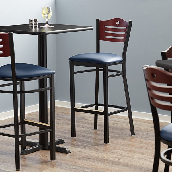 The detached navy vinyl seat for a Lancaster Table & Seating Bistro Bar Stool.