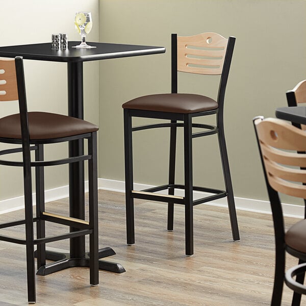 The detached dark brown vinyl seat for a Lancaster Table & Seating Bistro Bar Stool.